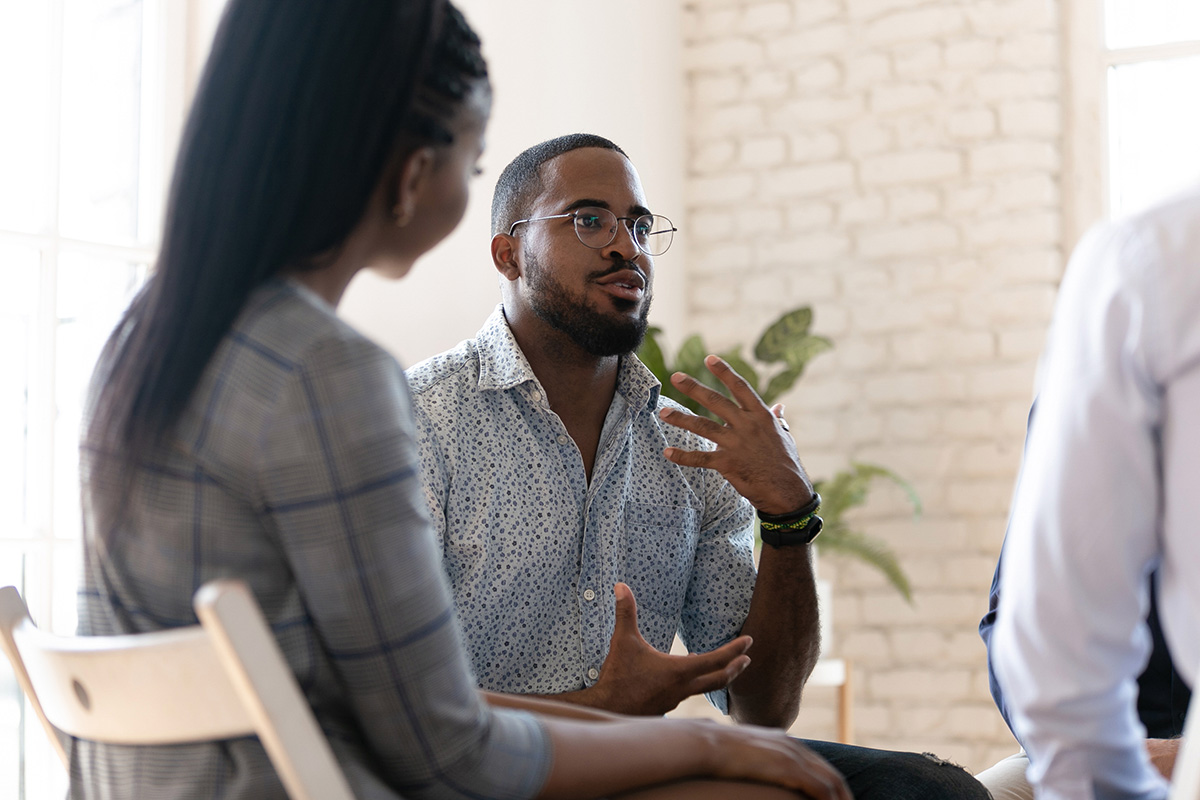 Small group participating in a mental health support session led by a therapist.