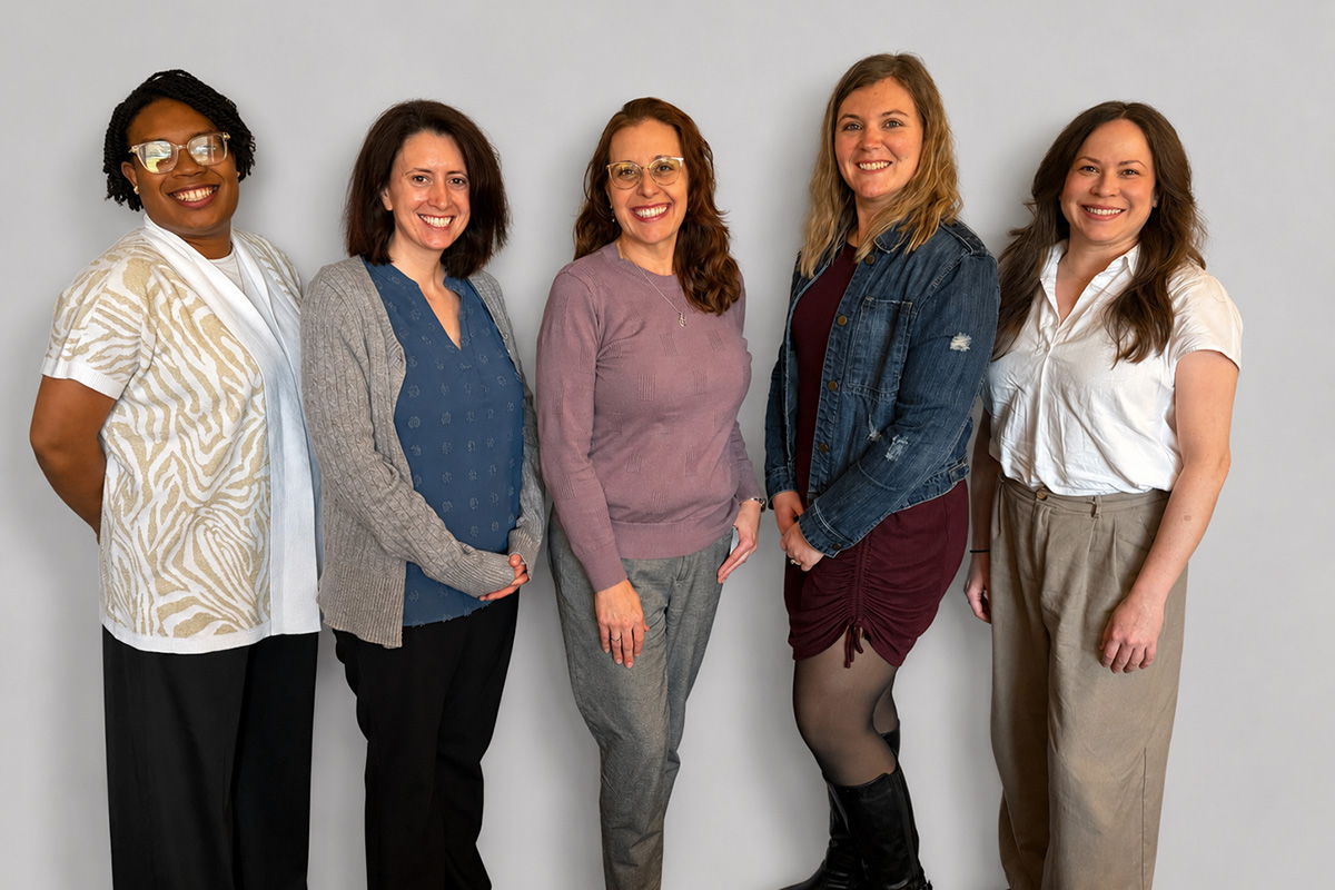 Five Bradley Counseling clinical team members standing together and smiling in front of a light gray background.